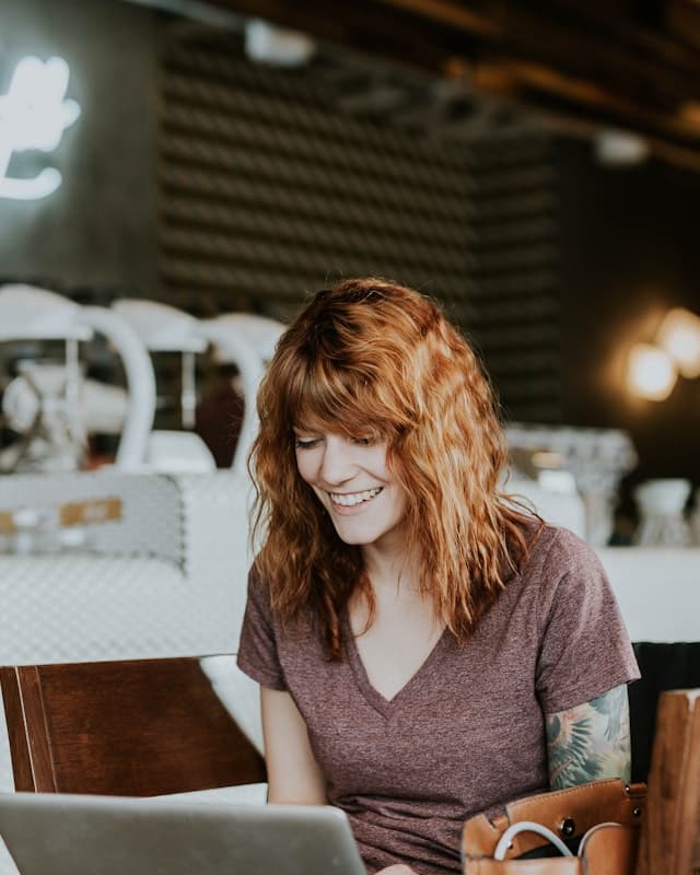 A small business owner working on a laptop