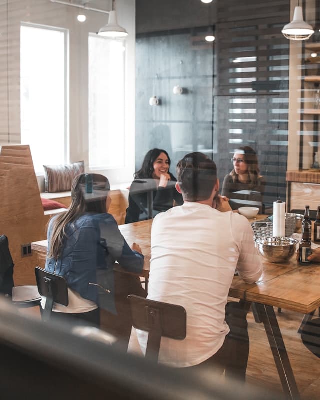 An agency team meeting around a table